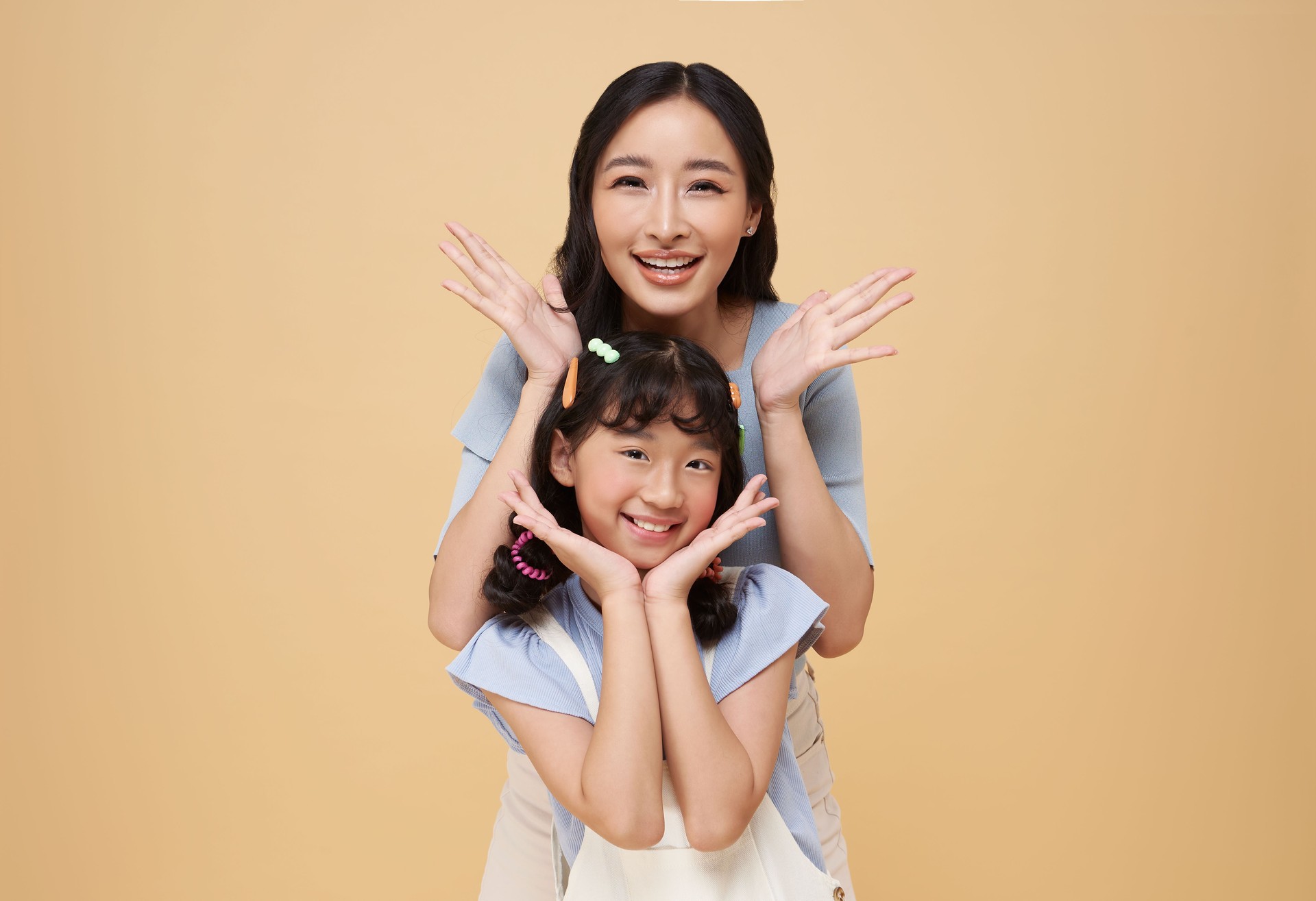 Portrait happy smiling Asian family hugging and love together on mother's day isolated on nude color background. happy mother's day.